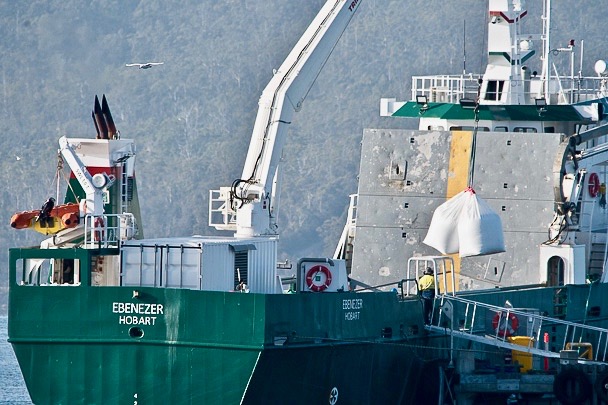 Loading feed pellets for salmon farms onto Tassal's supply ship Ebenezer at the company's Margate jetty, Tasmania.